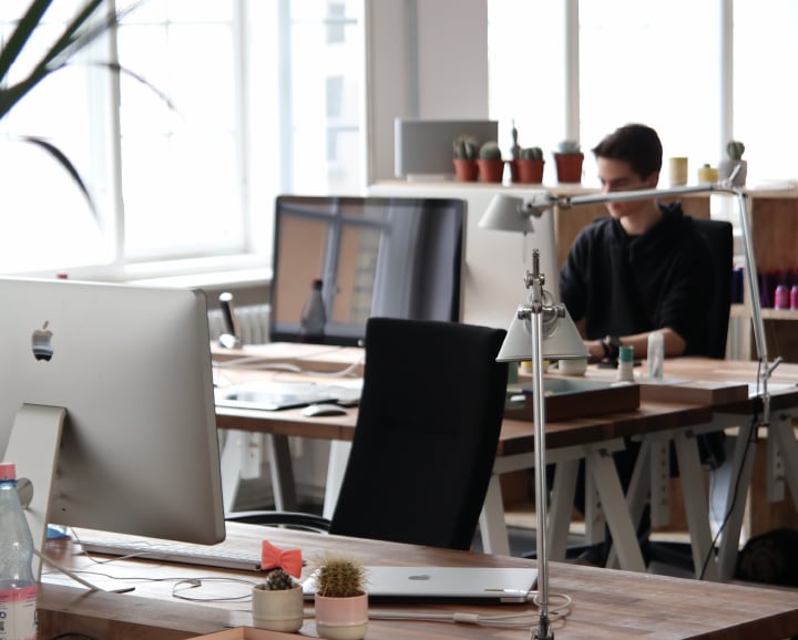 man at computer in the background